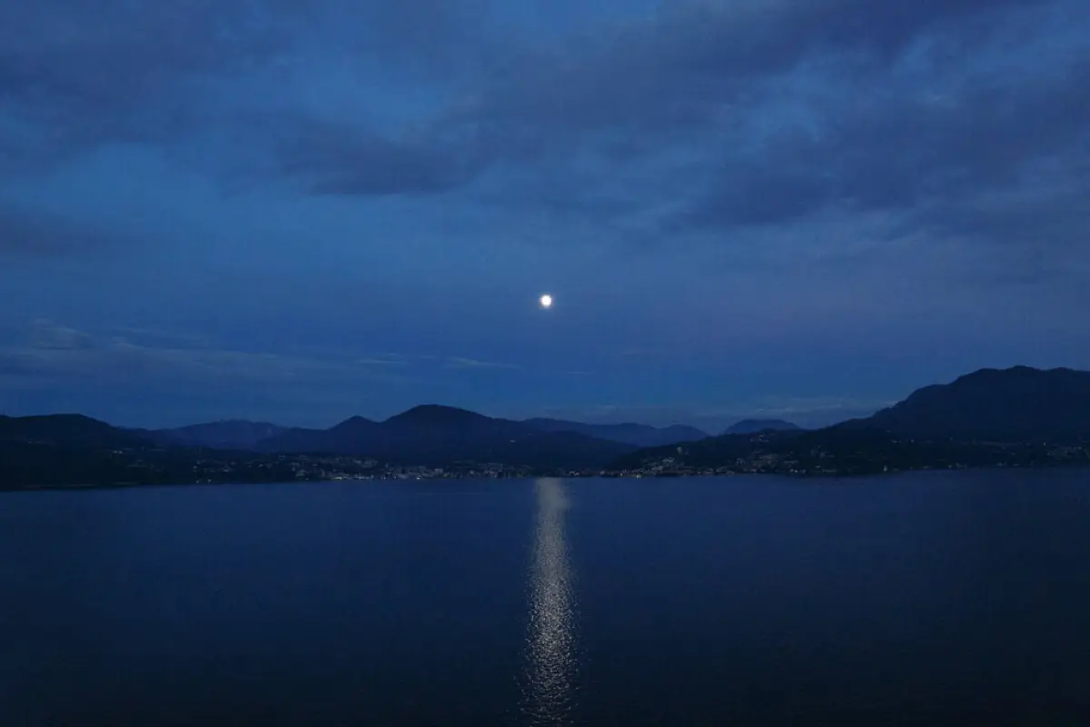 Beautiful evening landsсape. Lunar path on lake and mountain,  