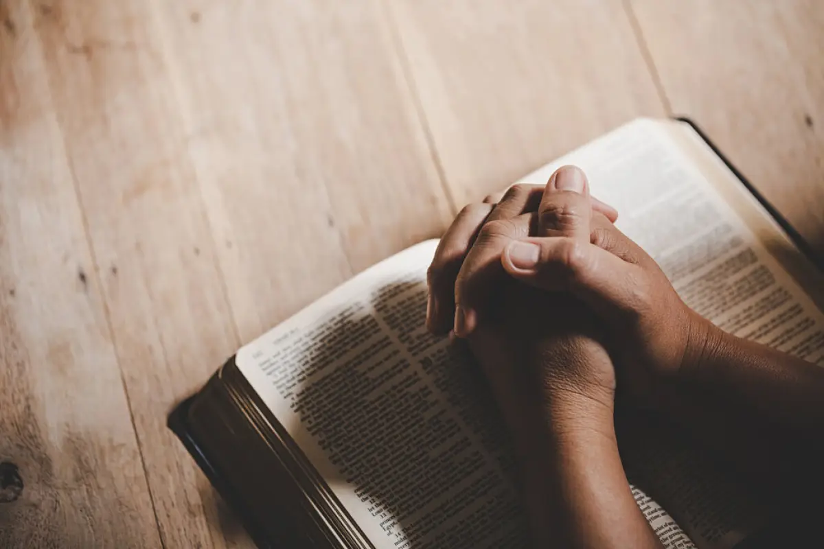 Spirituality and religion, Hands folded in prayer on a Holy Bibl, Spirituality and religion, Hands folded in prayer on a Holy Bible in church concept for faith.