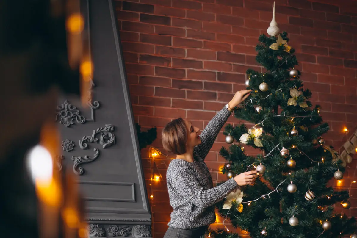 Pretty woman decorating Christmas tree,  