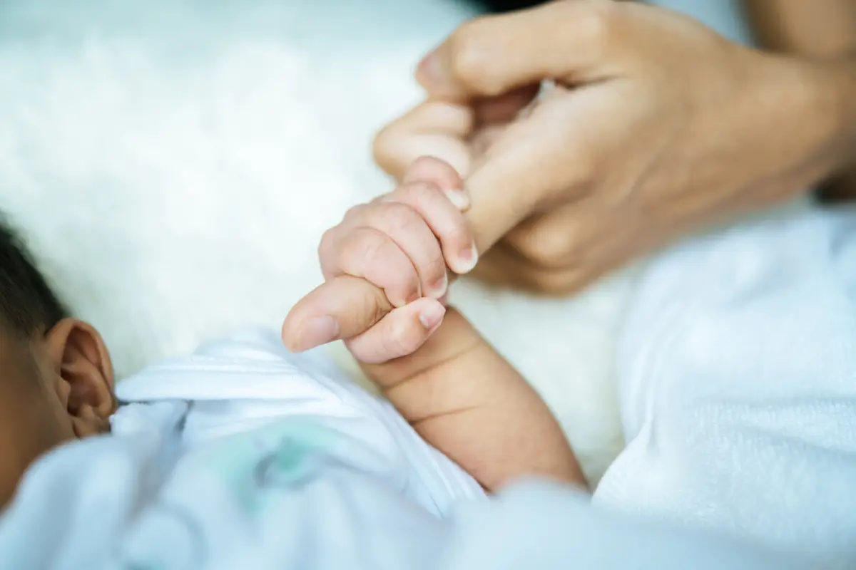 Newborn baby holding hands mom,  